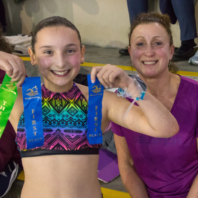 Swim school student Sienna Williams shows off her ribbons.